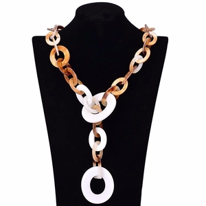 Detail view of long leopard print necklace with acrylic resin links on a display bust