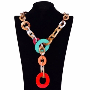 Detail view of bold acrylic links and resin textures on bohemian style long necklace