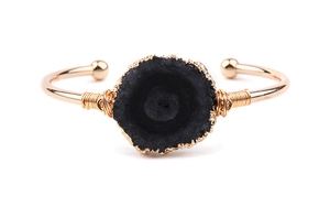 Vue détaillée du bracelet en cuivre doré fait main avec sertissage d'une grande pierre noire