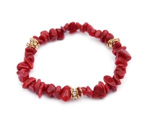 Close-up of natural irregular red stone beads bracelet with sparkling gold crystal rings
