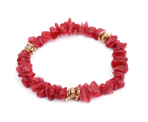 Macro view of red irregular natural stone beaded bracelet with golden crystal spacer rings