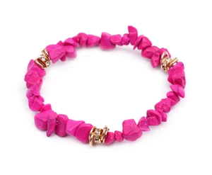 Close-up of fuchsia irregular natural stone beads and gold crystal-set metal spacers