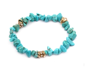 Detail of turquoise chips bracelet with gold spacers and sparkling rhinestones