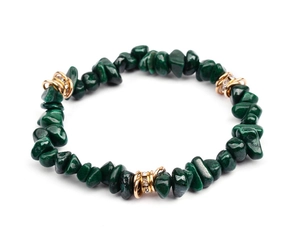 Close-up of green natural stone beads with gold rhinestone spacers on an elastic bracelet