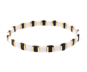 Detail of Miyuki Tila bead bracelet with alternating black white tiles and gold spacers