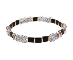 Detail of colorful Miyuki Tila bead bracelet with black tiles and golden spacer accents