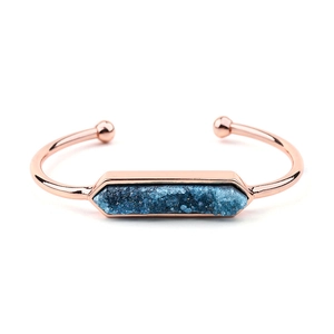 Dettaglio del bracciale aperto oro rosa con pietra druzy blu esagonale e sfere