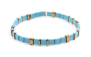 Detailed macro of sky blue Tila beads and gold striped metal spacers on woven bracelet