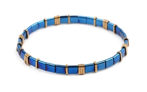 Detailed shot of handmade Miyuki Tila bead bracelet with blue squares and gold spacers