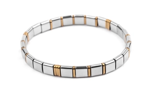 Detail view of elastic tila bead bracelet featuring alternating gold and silver metal cubes