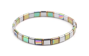 Macro shot of iridescent and silver metallic Tila beads on a stretch bracelet