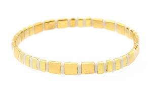 Close-up of geometric Tila bead bracelet with alternating gold and white square tiles