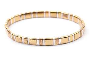 Close-up of golden and silver Tila beads on a handcrafted woven minimalist bracelet