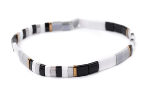 Detail shot of multicolor rectangular Tila beads in black, gold and white for bracelet
