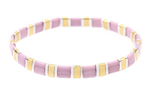 Detail of pink enamel tila tile bracelet with golden metal spacers and elastic string
