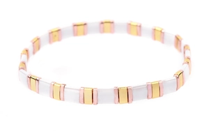 Detail of white and rose gold Tila bead bracelet with a polished metallic finish
