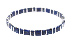 Macro detail of square blue Tila beads and polished silver metal spacers on a woven bracelet