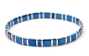 Detailed close-up of blue and silver square tila beads on a magnetic stretch bracelet