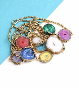 Detailed view of colorful natural druzy agate stones with gold faceted metal beads bracelet