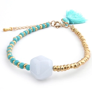 Detail view of crystal beaded bracelet with light blue silk tassel and gold extension chain