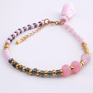 Detail of pink crystal beaded bracelet with soft silk tassel and adjustable gold clasp