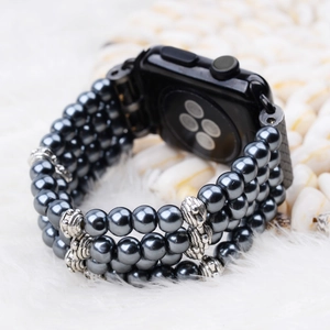 Detail of grey pearl apple watch band with silver metallic beads on white fur