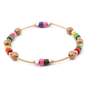 Detalle de cuentas de colores en una pulsera de resorte de metal espiral dorado