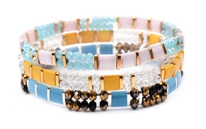 Detail of bohemian three-piece layered elastic bracelets with colorful Miyuki Tila beads