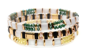 Detail view of bohemian stackable Miyuki Tila bracelets with colorful enamel and glass beads