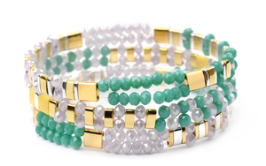 Close-up of bohemian multilayer bead bracelet with green faceted beads and metal charms