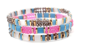 Macro detail of three layered elastic Miyuki Tila bead bracelets with colorful accents