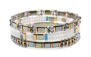 Detailed view of bohemian Miyuki Tila bead bracelets with gold blocks and crystal beads
