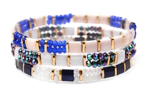 Close-up of Bohemian Miyuki Tila beaded bracelet set with gold spacers and blue crystals