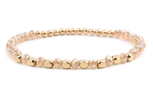 Close-up of golden metallic beads and champagne crystal beads on a handmade beaded bracelet