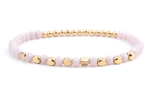 Detailed macro view of beaded bracelet with pink crystal beads and gold geometric spacers