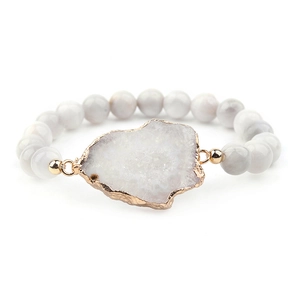 Détail des perles en pierre de marbre blanc et du cristal irrégulier avec bordure dorée
