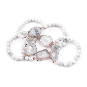 Détail de quatre bracelets en perles de pierre naturelle avec tranches de géode rosées