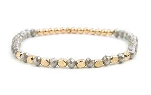 Detailed close-up of handmade beaded bracelet with gold metal and faceted grey crystal beads