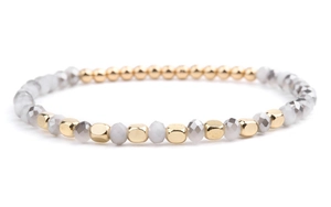 Detailed macro view of beaded bracelet with gold metal units and faceted crystal beads