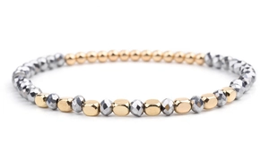 Macro detail of beaded bracelet with faceted silver beads and smooth gold metallic accents