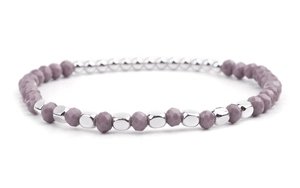 Macro detail of purple faceted beads and polished silver metallic accents on a beaded bracelet