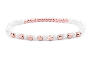 Detailed view of handmade beaded bracelet with white faceted beads and rose gold metal blocks