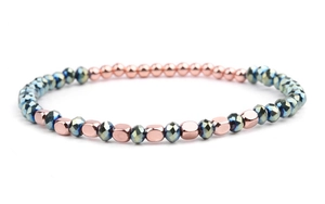 Detail of beaded bracelet with rose gold beads and iridescent faceted crystals