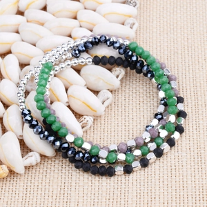 Detailed macro view of bohemian multilayer beaded bracelet set with glass and crystal beads