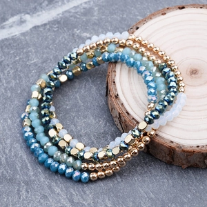 Detail of multi-layer blue crystal beaded bracelets with gold faceted metal accents