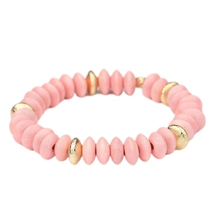 Detail of pink matte wooden beads and textured golden spacers on the elastic bracelet