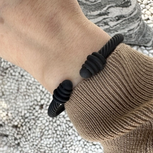 Matte black cable twisted open bangle bracelet with ball ends for a minimalist look