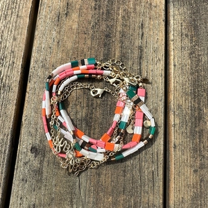 Detail of multi-layer Tila bead bracelet with Hope and Faith metal letter charms