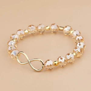 Elegant champagne kristallen kralenarmband met gouden oneindigheidssymbool en metalen kralen