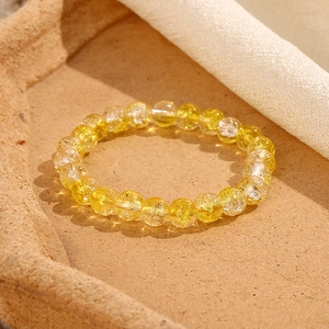 Dettaglio del bracciale con perline di vetro da 8 mm giallo e bianco con texture crackle